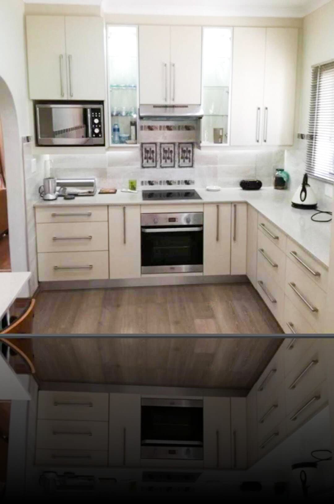 Kitchen renovation with cream gloss cabinetry, built-in oven and glass-panel display units